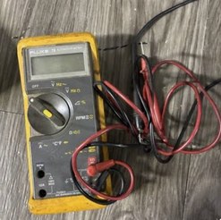 Fluke 78 multimeter in a yellow holster with red and black test leads